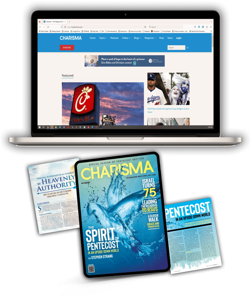 Charisma Media website on a laptop with Charisma Media magazines under it.